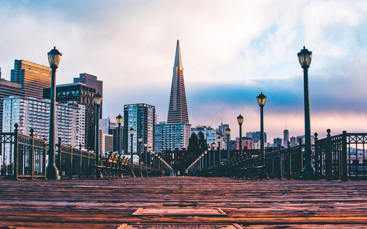 city skyline under white clouds during daytime