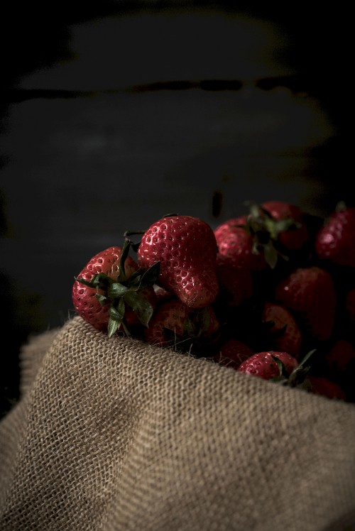 Image red strawberries on brown textile