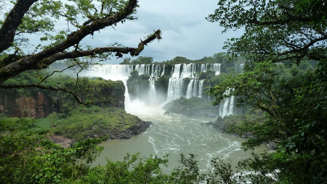 waterfalls under white cloudy sky during daytime