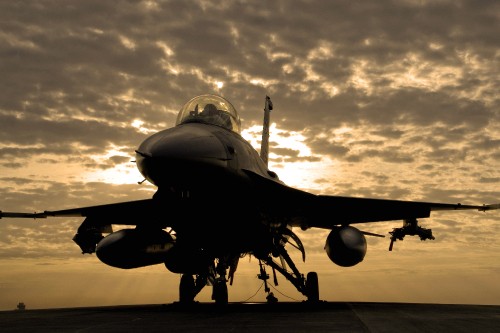 Image black fighter plane under cloudy sky during daytime