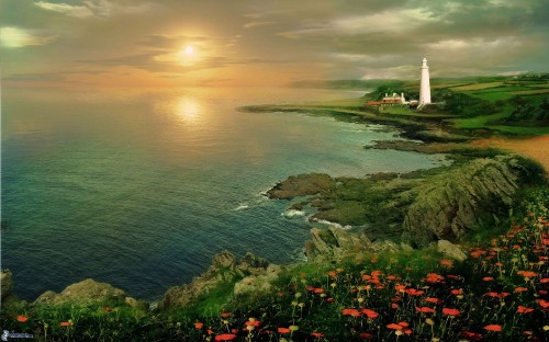 Image white lighthouse on green grass field near body of water during sunset