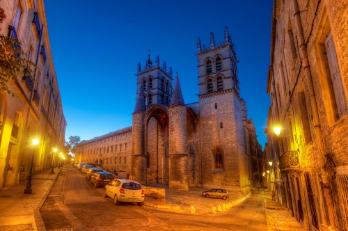 Image cars parked beside brown concrete building during night time