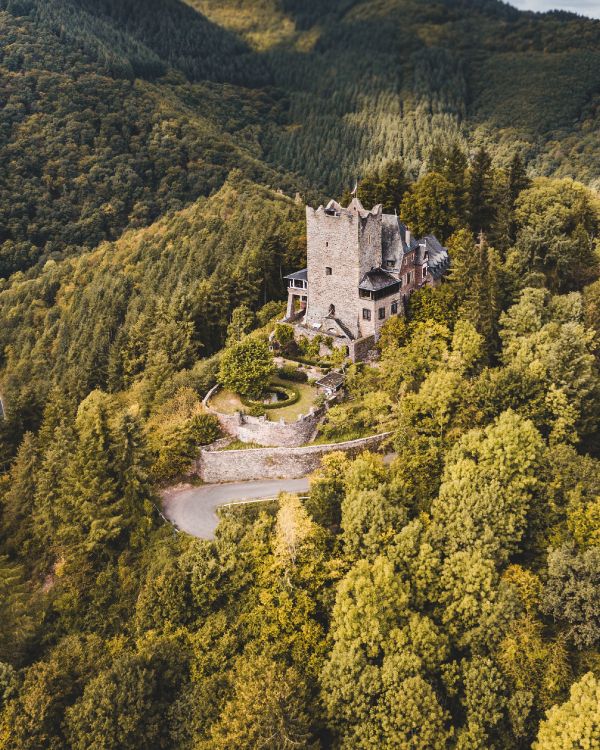 White Concrete Castle on Green Mountain During Daytime. Wallpaper in 2209x2761 Resolution