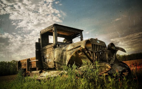 Image vintage car on green grass field under cloudy sky