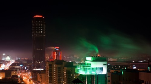 Image city skyline with lights turned on during night time