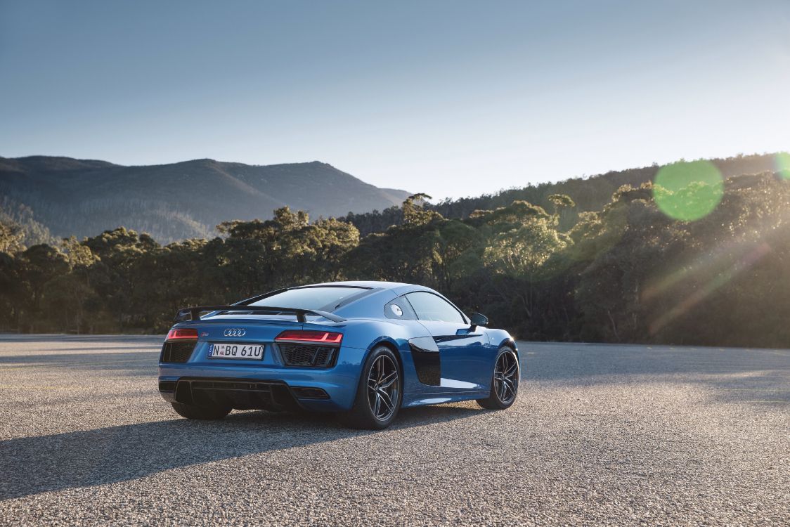 blue porsche 911 on gray dirt road during daytime