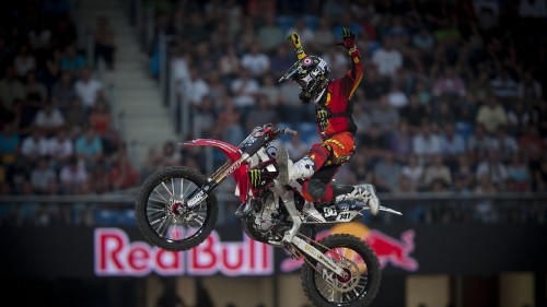 Image man in red and black motocross suit riding motocross dirt bike