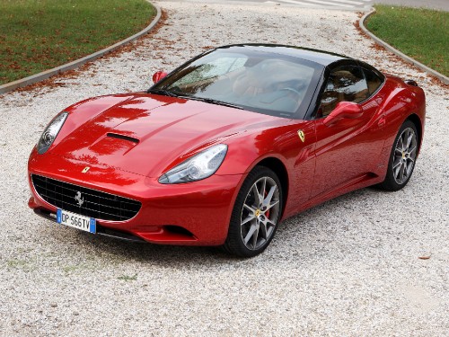 Image red ferrari 458 italia parked on gray concrete road during daytime