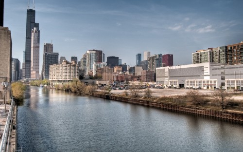 Image city buildings near body of water during daytime