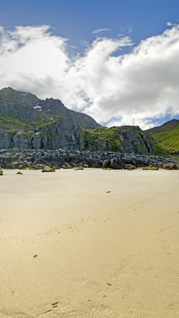 Image green mountain beside body of water during daytime