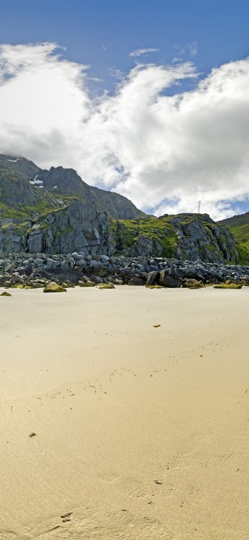 Image green mountain beside body of water during daytime