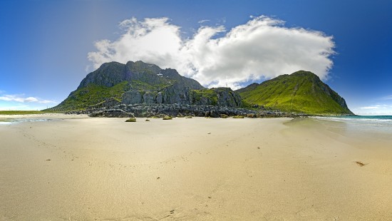 Image green mountain beside body of water during daytime