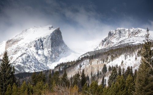 Image snow covered mountain under cloudy sky during daytime