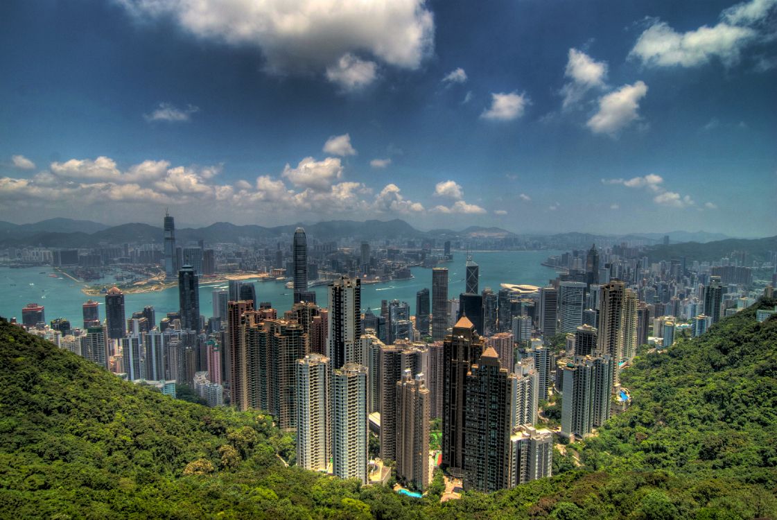 city skyline under blue and white cloudy sky during daytime