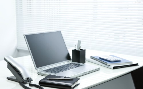 Image silver and black laptop computer on white table