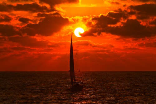 Image silhouette of sailboat on sea during sunset