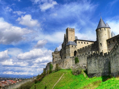 Image gray concrete castle under blue sky and white clouds during daytime