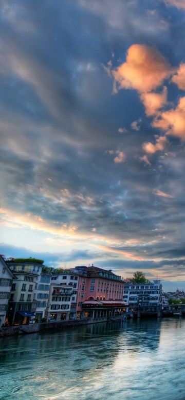 Image body of water between buildings under cloudy sky during daytime