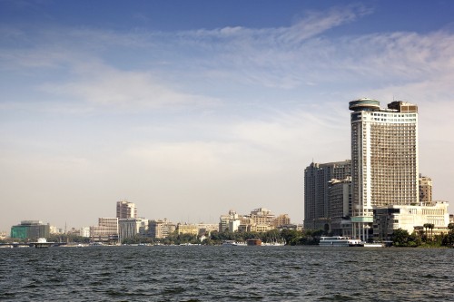 Image city skyline across body of water during daytime