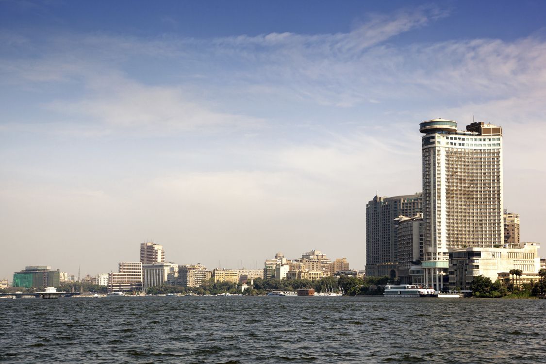 city skyline across body of water during daytime