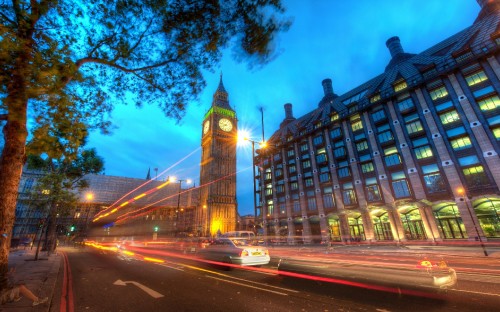 Image time lapse photography of cars on road near building during night time