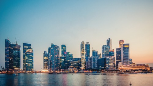 Image city skyline across body of water during daytime