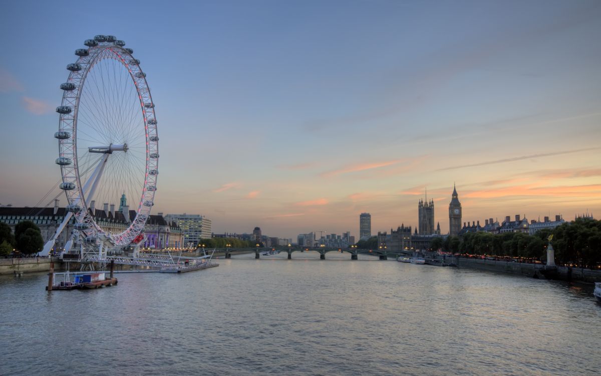 ferris wheel near body of water during daytime