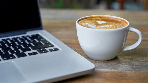 Image white ceramic cup with brown liquid inside