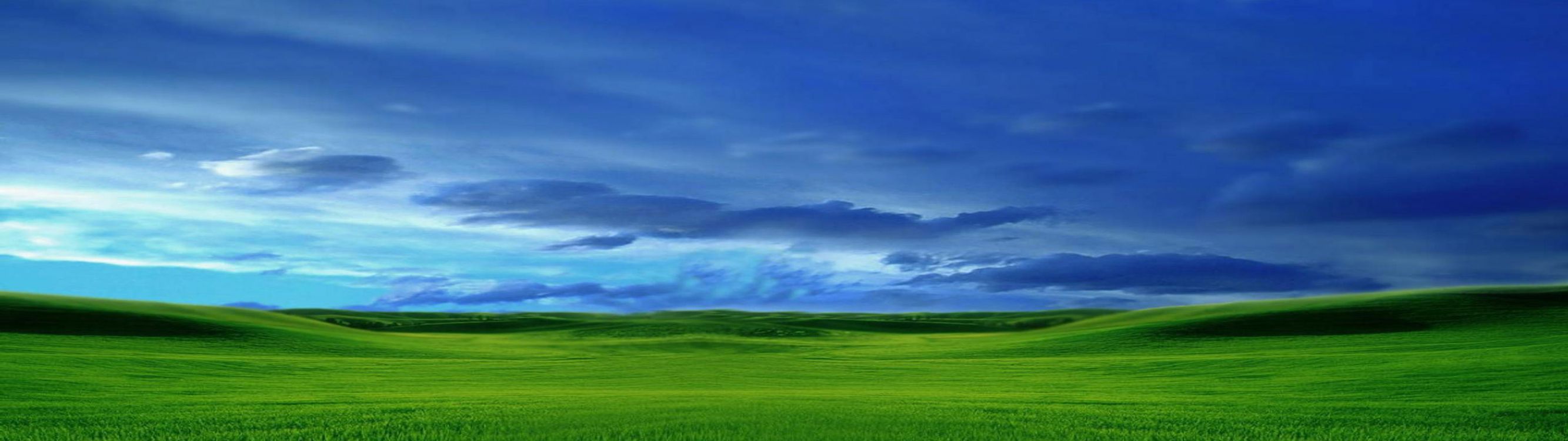 Green Grass Field Under Cloudy Sky During Daytime. Wallpaper in 3840x1080 Resolution