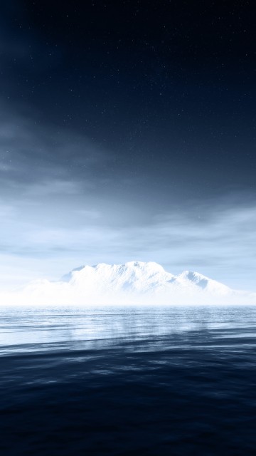 Image snow covered mountain near body of water during night time