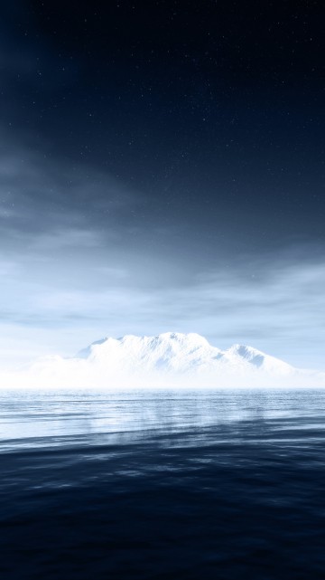 Image snow covered mountain near body of water during night time