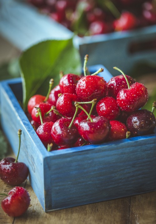 Image red cherries in brown wooden crate