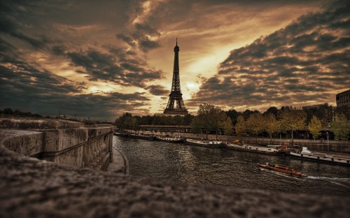 Image eiffel tower under cloudy sky during daytime