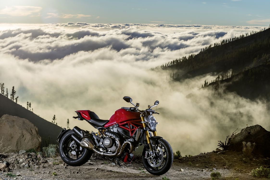 Red and Black Sports Bike on Brown Field Under White Clouds During Daytime. Wallpaper in 3508x2341 Resolution
