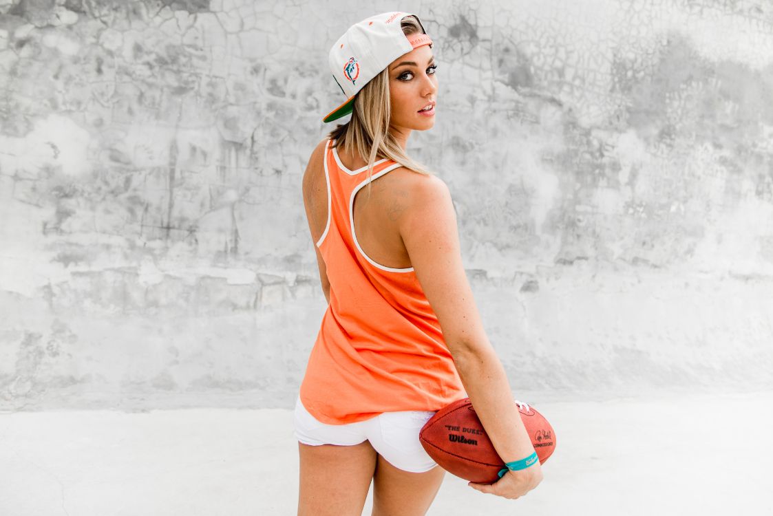 Woman in Red Tank Top and White Shorts Holding Basketball. Wallpaper in 5946x3968 Resolution
