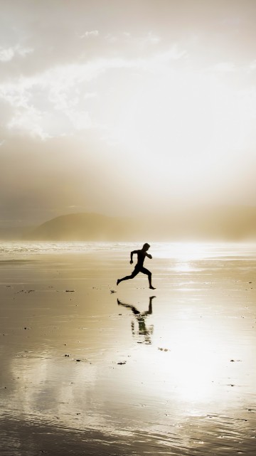 Image person walking on beach during daytime