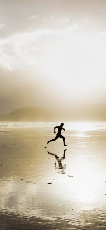 Image person walking on beach during daytime