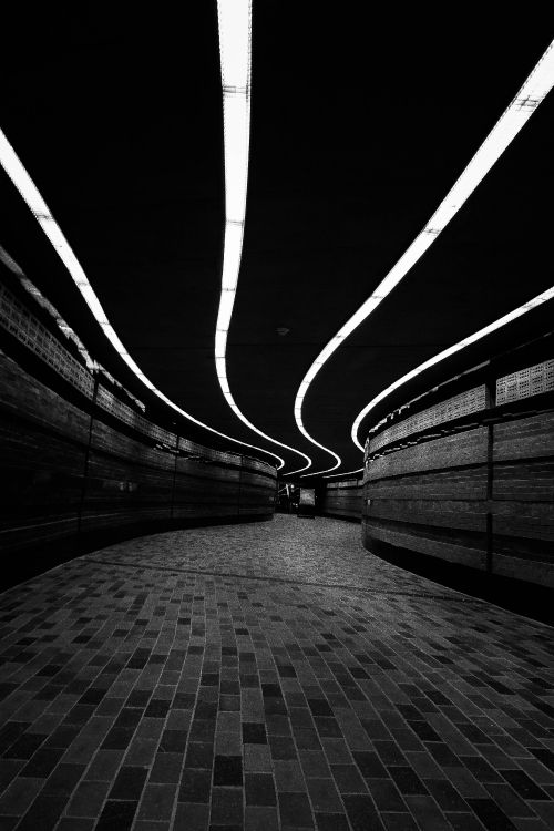 grayscale photo of a tunnel