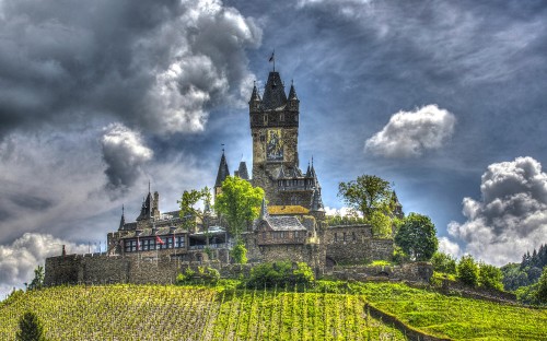 Image green and yellow castle under cloudy sky