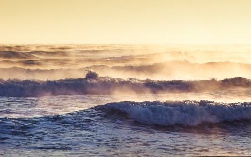 Image ocean waves crashing on shore during daytime