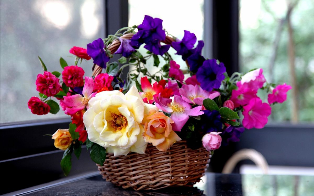 white and purple flower bouquet on woven basket