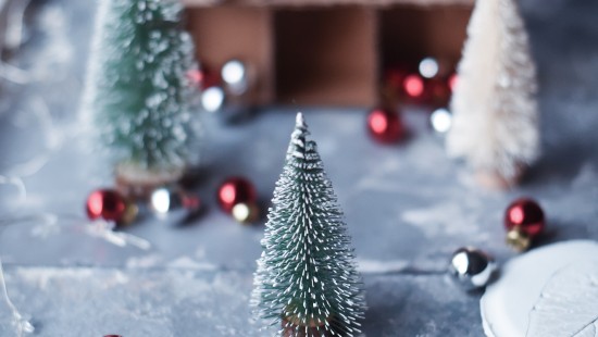 Image green christmas tree with baubles and string lights