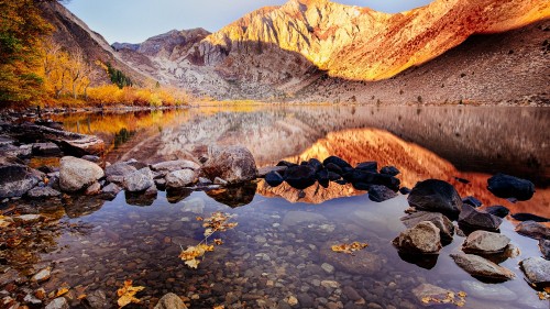 Image brown rocky mountain beside river during daytime