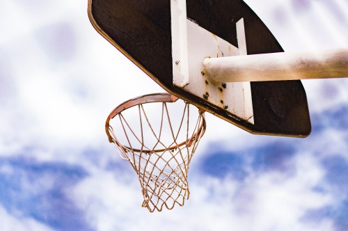 Image white basketball hoop under blue sky during daytime