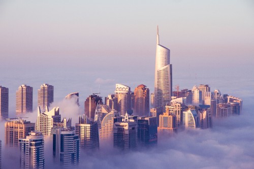 Image high rise buildings under white sky during daytime