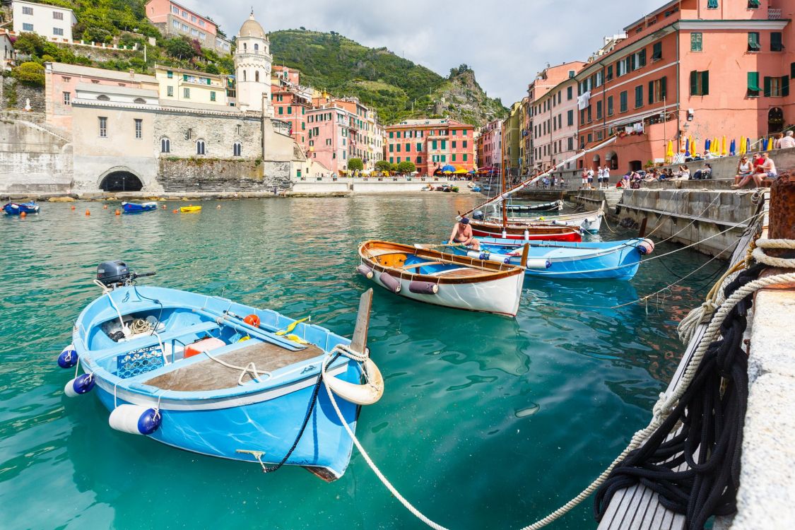 blue and white boat on river near buildings during daytime