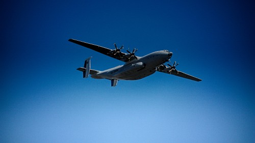 Image gray and black airplane under blue sky during daytime