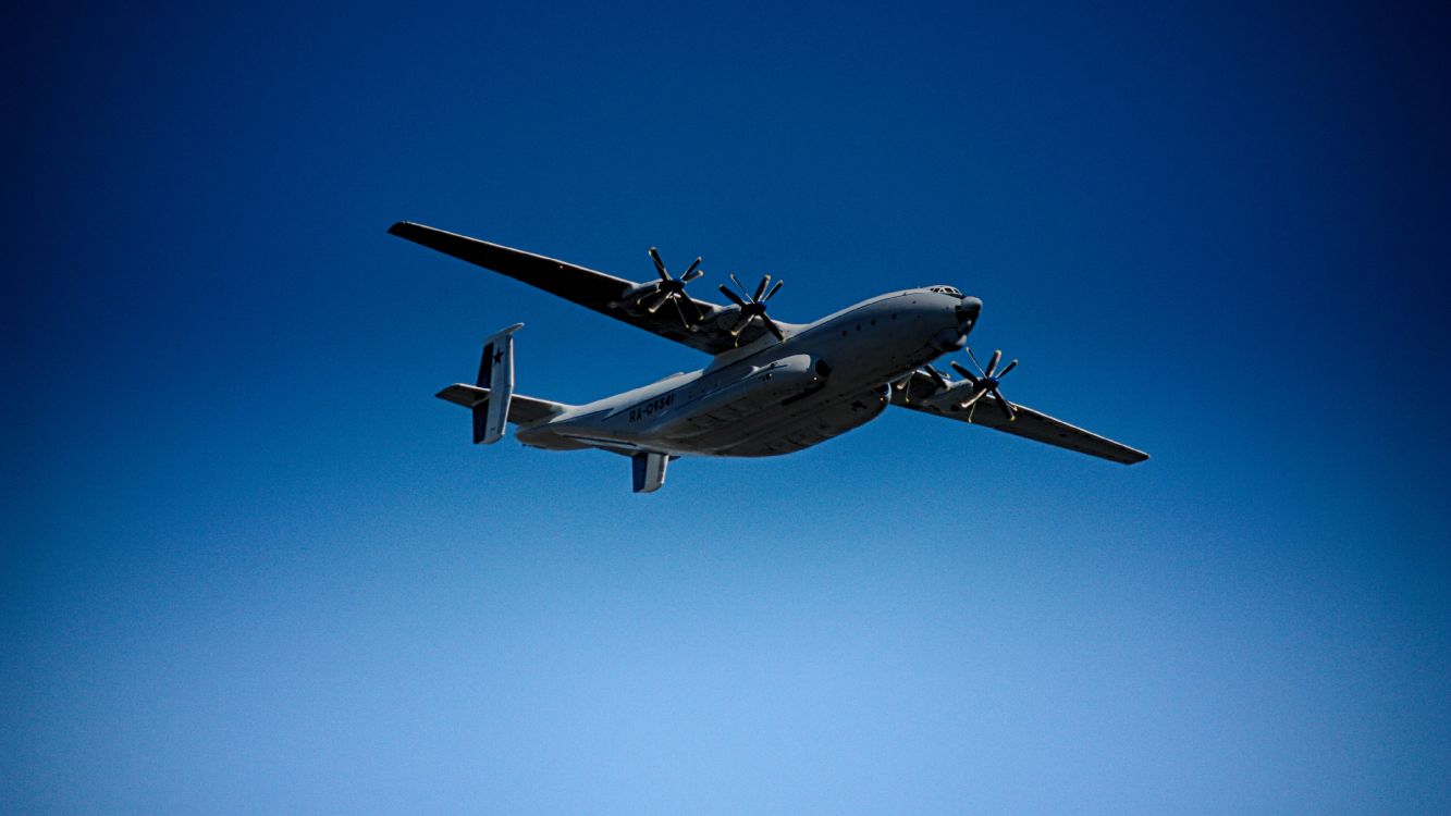 gray and black airplane under blue sky during daytime