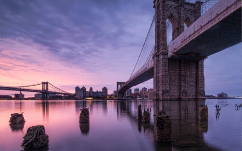 Image brown bridge over body of water during daytime