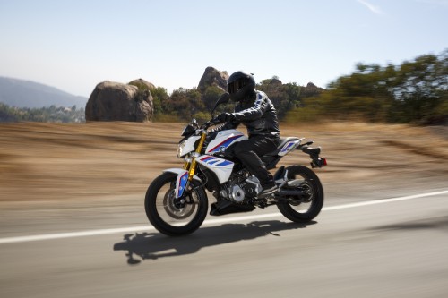 Image man in black jacket riding blue and white sports bike on road during daytime